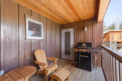 a room with a desk and a chair on a balcony at The Mountain Project #2 in Rossland