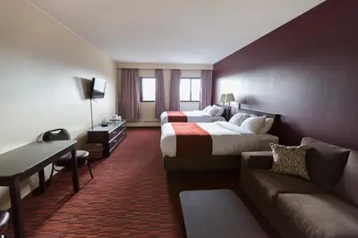 a hotel room with a bed and a couch at Argyll Plaza Hotel in Edmonton