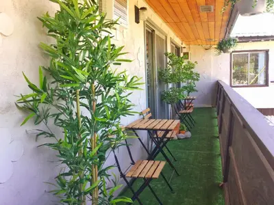 a porch with benches and plants on a balcony at Celadon Lodge in Radium Hot Springs