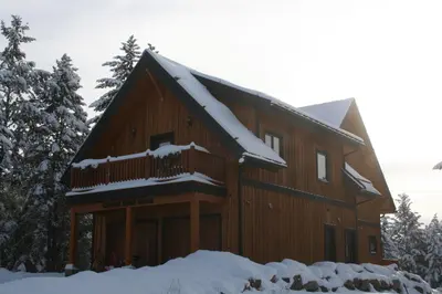 a log cabin with snow on the roof at Canyon Ridge Lodge in Golden