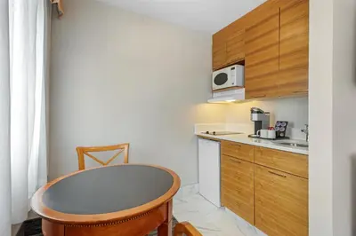 a small kitchen with a table and a microwave at Best Western Plus Suites Downtown Calgary in Calgary