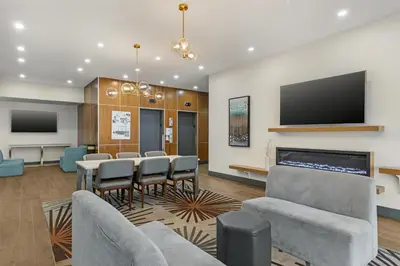 a meeting room with a table and chairs and a flat screen tv at Best Western Plus Suites Downtown Calgary in Calgary
