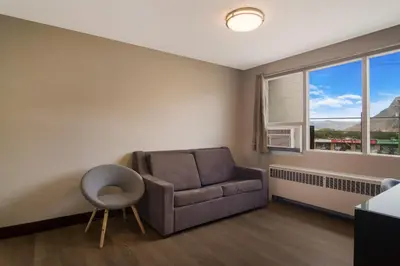 a living room with a couch and a window at Canadas Best Value Inn & Suites Kamloops in Kamloops