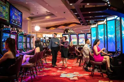 a group of people standing in a casino at River Cree Resort & Casino in Edmonton