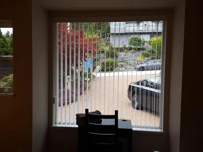 a window with a view of a car in a parking lot at Emperial Suites in North Vancouver