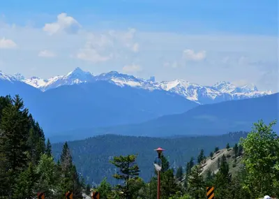 a view of a mountain range with snow capped mountains at Mountain View Radium Condo - Copper Horn Village in Radium Hot Springs