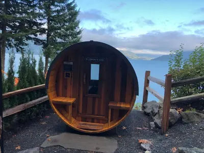 a small wooden boat sitting next to a fence at The Lodge on Harrison Lake in Harrison Hot Springs
