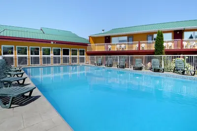 a large swimming pool in front of a hotel at Days Inn by Wyndham Penticton Conference Centre in Penticton