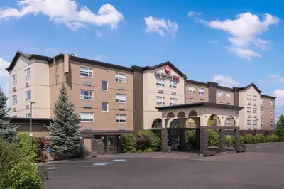 a hotel building with an archway in a parking lot at Best Western Plus Kamloops Hotel in Kamloops