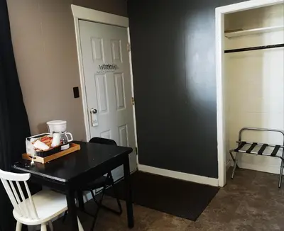 a room with a black table and chairs and a door at Overlook Inn & Cabins in Clearwater