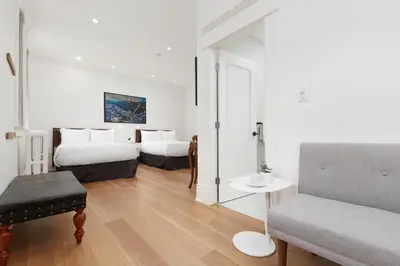 a living room with two beds and a couch at Victorian Hotel in Vancouver