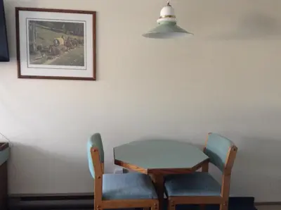 a table and two chairs and a table and a table and chairs at The Ranchland Inn Kamloops in Kamloops