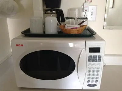 a microwave with a tray on top of it at The Ranchland Inn Kamloops in Kamloops