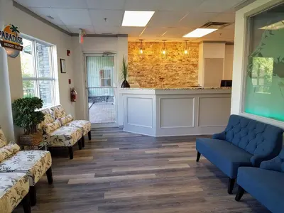 a waiting room with blue couches and a counter at Sunset Resorts Canmore and Spa in Canmore