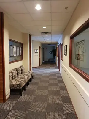 a hallway in a hospital with couches in a corridor at Sunset Resorts Canmore and Spa in Canmore