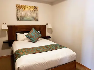 a small bedroom with a bed with at Sunset Resorts Canmore and Spa in Canmore