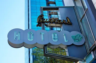 a sign for a hotel on the side of a building at The Burrard in Vancouver