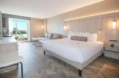 a large white bed in a hotel room at Coast Victoria Hotel & Marina by APA in Victoria