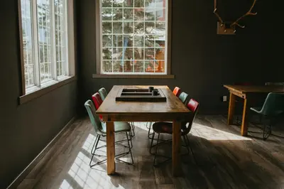 a dining room with a wooden table and chairs at Creekside Villa in Canmore