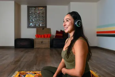 a woman wearing headphones sitting in a room at Creekside Villa in Canmore