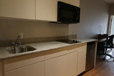 a kitchen with a sink and a counter top at Baymont by Wyndham Fort McMurray in Fort McMurray