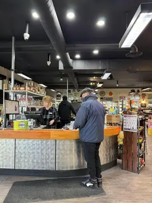 a group of people standing at a counter in a store at Divya Sutra Plaza and Conference Centre, Vernon, BC in Vernon