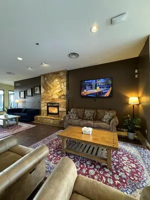 a living room with a couch and a table at Divya Sutra Plaza and Conference Centre, Vernon, BC in Vernon