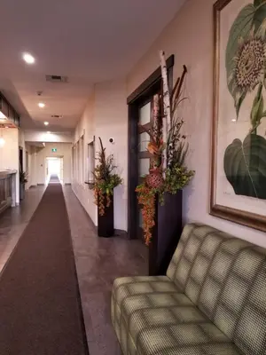 a hallway with a couch in a building at Western Budget Motel Leduc #3 in Leduc