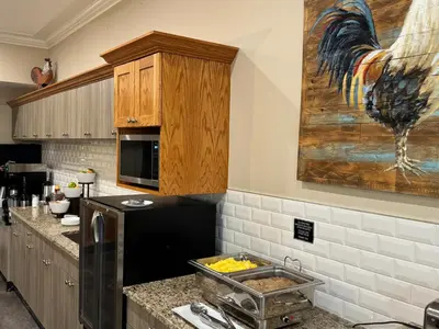 a kitchen with a sink and a painting on the wall at Western Budget Motel Leduc #3 in Leduc