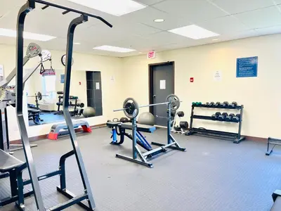 a gym with treadmills and weights at Days Inn by Wyndham Grande Prairie in Grande Prairie