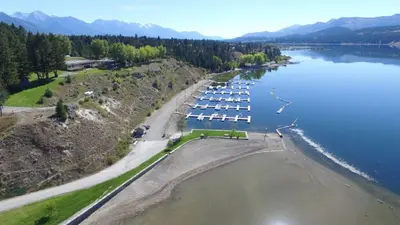 an aerial view of a marina with boats in the water at Akiskinook Sandy Beach Lakefront Resort! Tennis, Pickle, Basket Ball Courts, Indoor Pool, Hot Tub, Squash Court! Short Drive to Radium or Fairmont Hot Springs! in Invermere