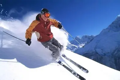 a man is skiing down a snow covered slope at Akiskinook Sandy Beach Lakefront Resort! Tennis, Pickle, Basket Ball Courts, Indoor Pool, Hot Tub, Squash Court! Short Drive to Radium or Fairmont Hot Springs! in Invermere