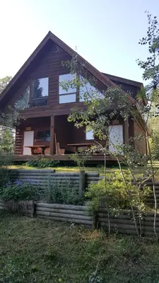 a house with a fence in front of it at Wettstone Guest Ranch in Bridge Lake