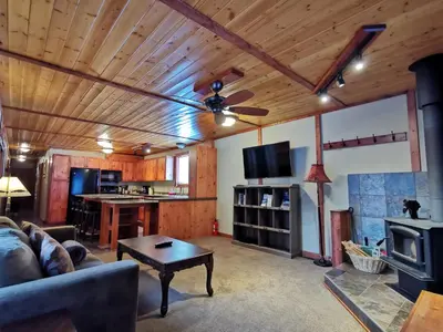 a living room with a couch and a table at Cedar House Restaurant & Chalets in Golden