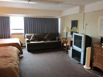 a hotel room with a couch and a tv at Moby Dick Inn in Prince Rupert