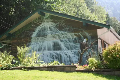 a mural of a waterfall on the side of a house at Camperland RV Resort & Cabins in Rosedale