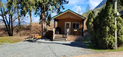 a small building with a bench in front of it at Camperland RV Resort & Cabins in Rosedale