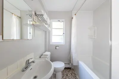 a white bathroom with a sink and a toilet at 2400 Motel in Vancouver