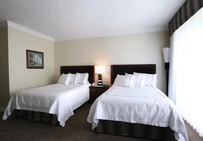 a hotel room with two beds and a window at Granville Island Hotel in Vancouver