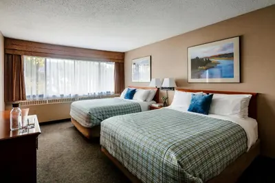 a hotel room with two beds and a window at Lobstick Lodge in Jasper