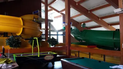 a room with a boat and a pool table at Douglas Fir Resort & Chalets in Banff