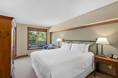 a hotel room with a large bed and a window at Horstman House by Whistler Premier in Whistler
