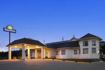 a building with a street sign in front of it at Days Inn by Wyndham Hinton in Hinton