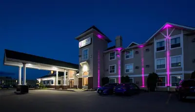 a hotel with purple lights in a parking lot at Coast Hinton Hotel in Hinton