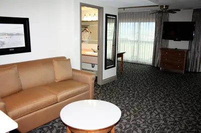 a living room with a couch and a television at The Royal Anne Hotel in Kelowna