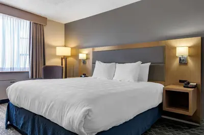 a large white bed in a hotel room at Best Western Plus Vancouver Airport Hotel in Vancouver