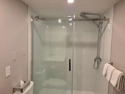 a bathroom with a glass shower with a toilet at Best Western Plus Vancouver Airport Hotel in Vancouver