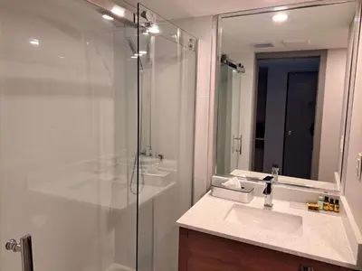 a bathroom with a shower and a sink and a mirror at Best Western Plus Vancouver Airport Hotel in Vancouver