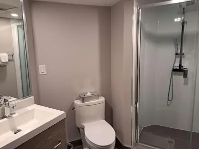 a bathroom with a shower and a toilet and a sink at Best Western Plus Vancouver Airport Hotel in Vancouver