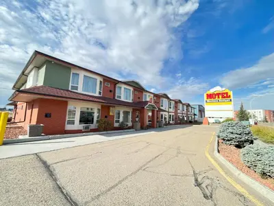 a building with a motel sign on the side of a road at Western Budget Motel #1 Leduc/Nisku in Leduc